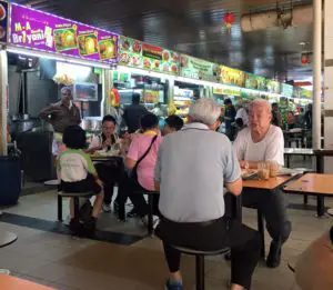 Singapore locals hanging out and enjoying the local food at a hawker centre