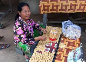 A Cambodian street vendor with palm sugar sweets. One of the most important travel commandments is to learn from those around us!