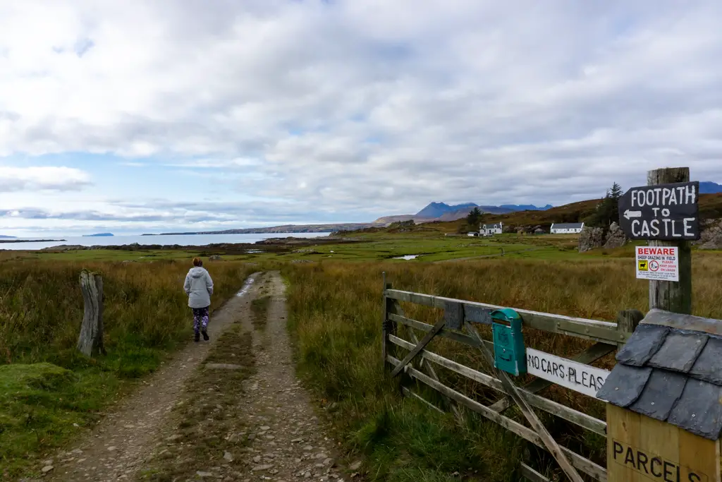 Girl walks down Scottish farm track