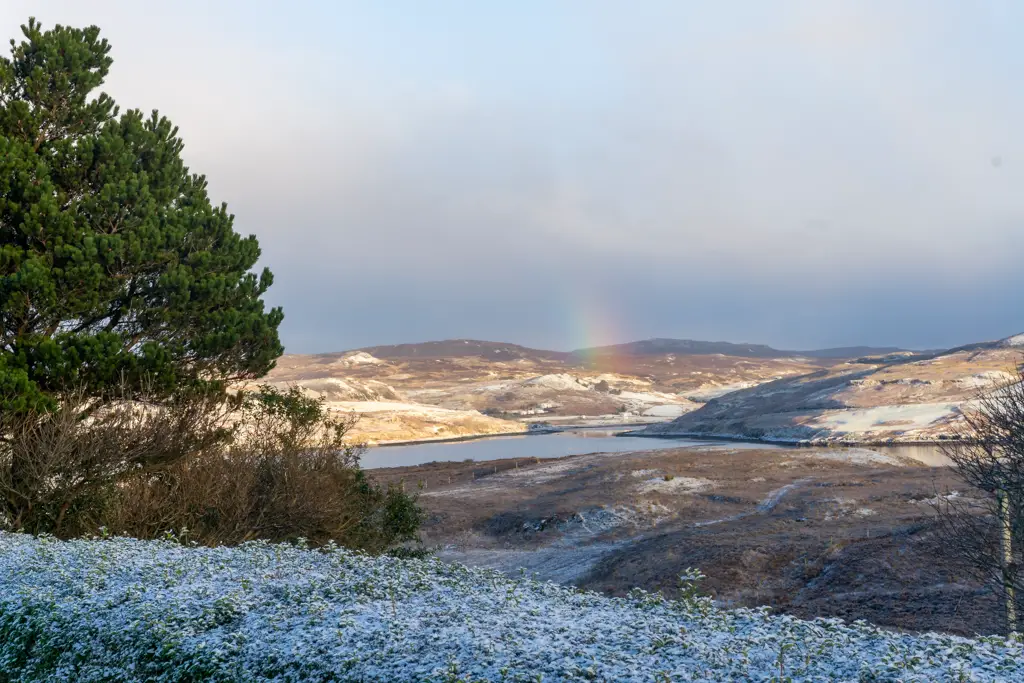 Rainbow over snowy hills - Isle of Skye 